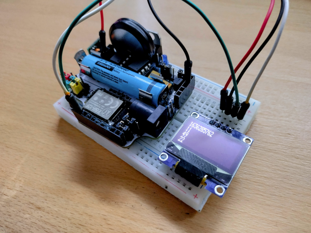 The ResourciBoard prototype pushing a timestamp, and the current hour, minute, and second to an OLED - All via a AAA battery!