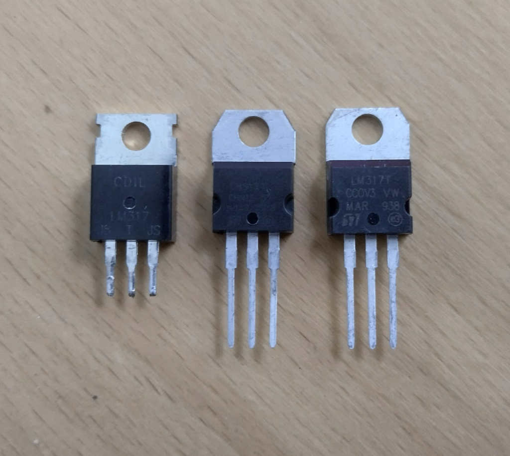 Original working "CDIL" LM317T on the left, the faulty/fake one in the middle which people are guessing might be an LM317L internally, and a working LM317T on the right.