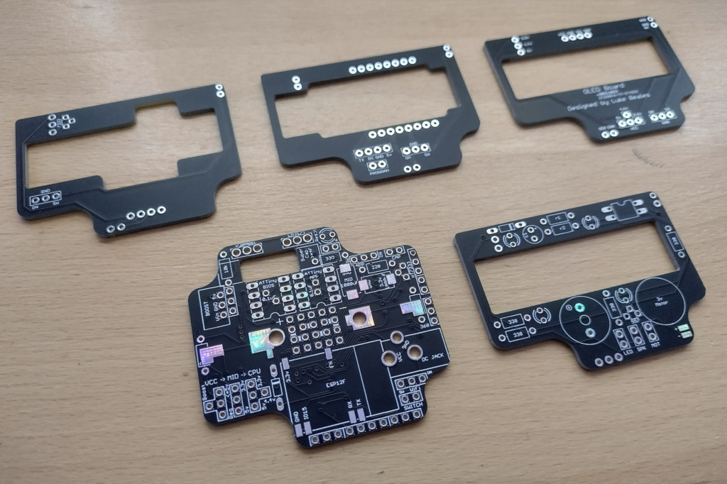 The latest round of cleaner and refined ResourciBoard, GPS board with more clearance, ESP32-Cam board with more clearance, the existing OLED board as it works, and the new Pager board for trials.