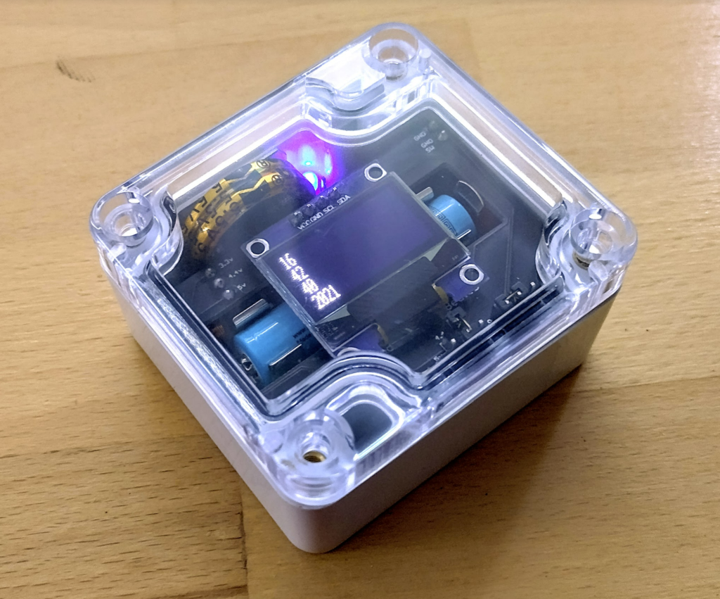 Resourciboard - Battery powered ESP12 with OLED showing the current time, within an enclosure.