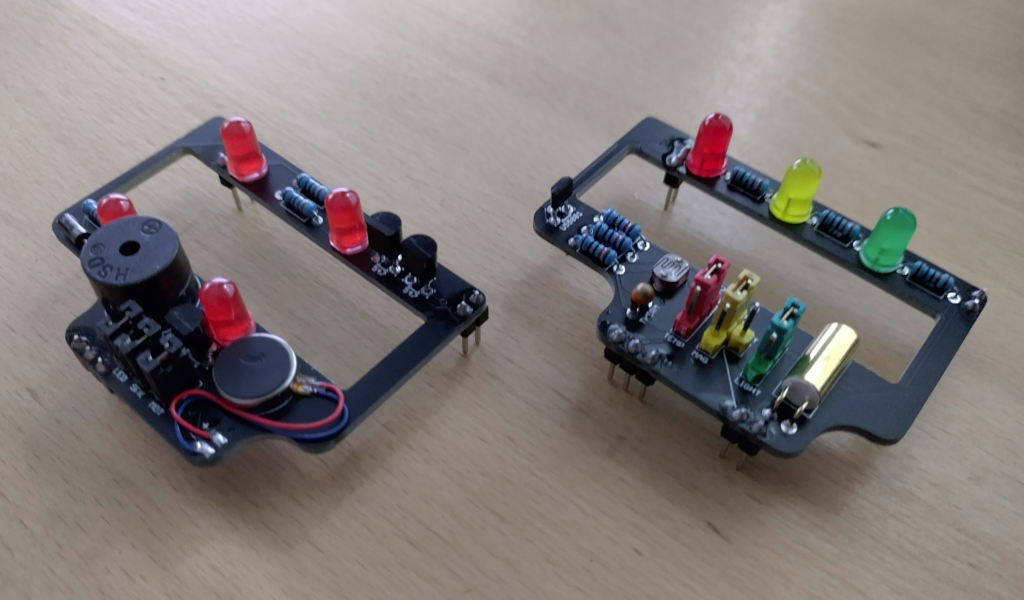 The latest additions to the ResourciBoard family, the Pager board on the left with LEDs, Beeper, and vibrating motor, and IO board on the right with LEDs, Hall effect sendor, Light resistor, Thermistor, and Tilt switch.