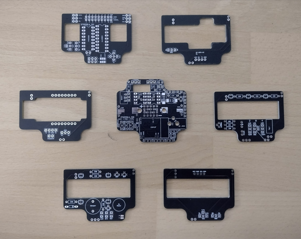 Black unsoldered PCBs of the ResourciBoard, OLED, GPS, IO, Pager, ESP32-Cam, and Shift.