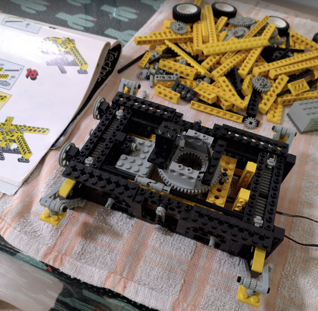 Lower half of the Lego Technic 8094 crane complete, with the upper half waiting in the background